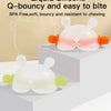 Pink and white silicone bunny-shaped baby teether with orange handles shown on a white surface.