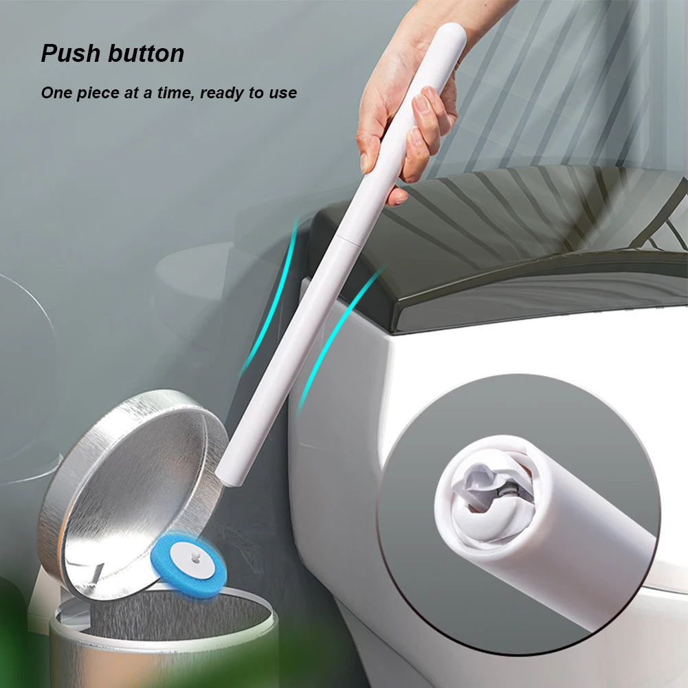 A hand is pushing a white wand from a wall-mount holder onto a toilet bowl for cleaning.