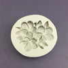 A white silicone mold shaped like a three-dimensional flower for baking and crafting.
