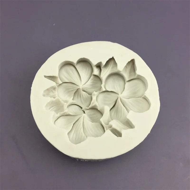 A white silicone mold shaped like a three-dimensional flower for baking and crafting.