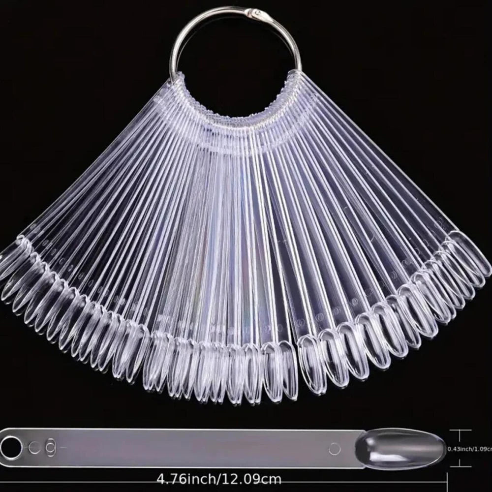 Clear acrylic false nail tips kit with a fan-like design displayed on a ruler.