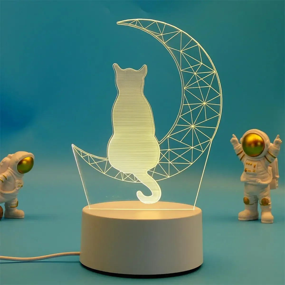 A clear acrylic silhouette of a cat inside a crescent moon shape, illuminated by LED light.