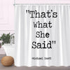 A white fabric shower curtain featuring black text that reads That's what she said and the name Michael Scott.
