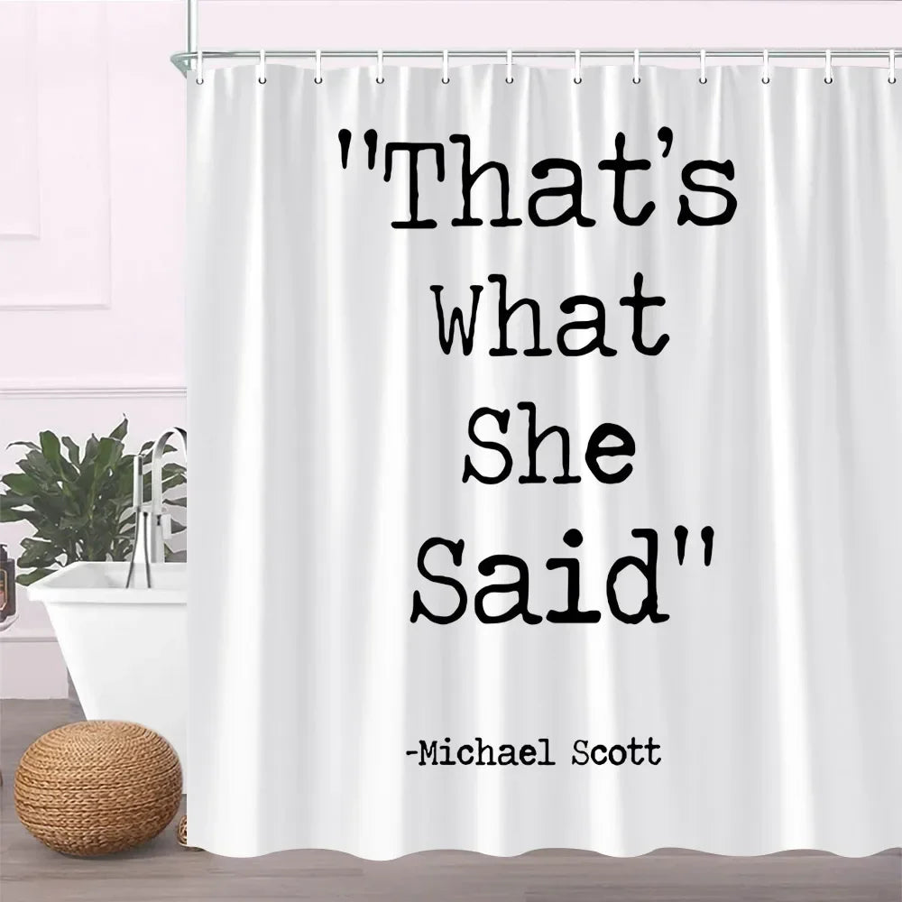 A white fabric shower curtain featuring black text that reads That's what she said and the name Michael Scott.