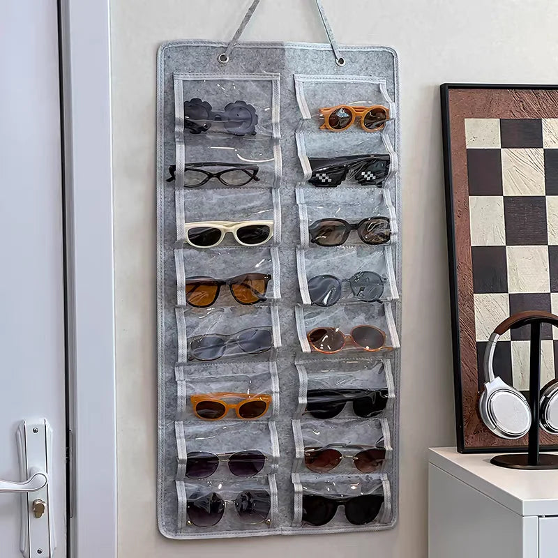 A vertical felt organizer with 16 slots for storing and displaying various pairs of sunglasses and eyeglasses.