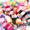 Assorted polymer clay beads in summer fruit designs, including orange, pink, and white patterns.