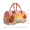 A pink quilted travel duffle bag featuring a guitar design and floral embroidery on its exterior.