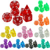 A set of seven transparent crystal polyhedral dice in various colors including red, green, orange, and clear.