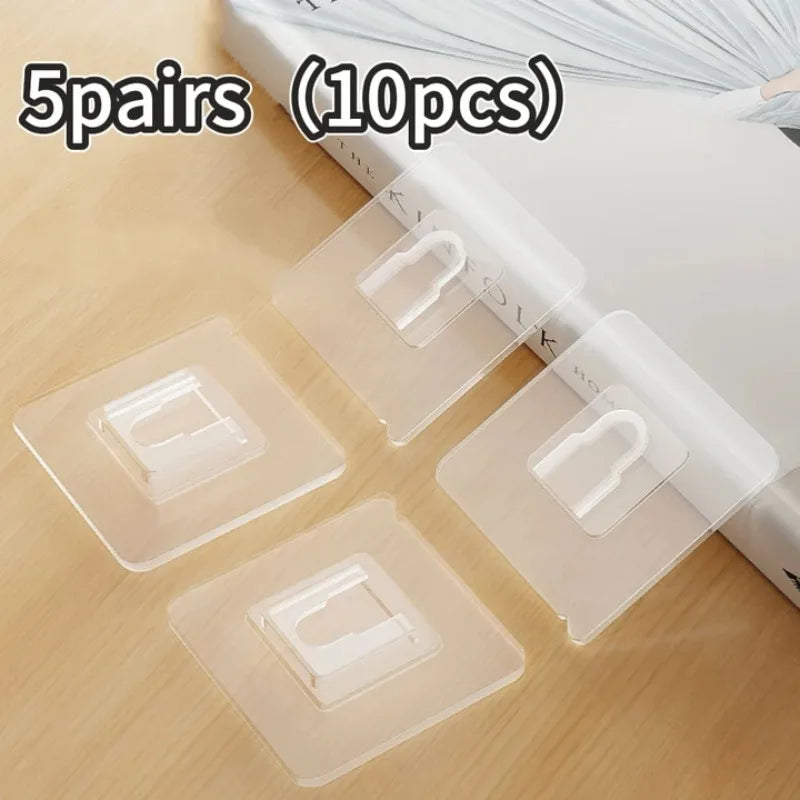 Five pairs of transparent adhesive wall hooks are shown on a wooden surface.