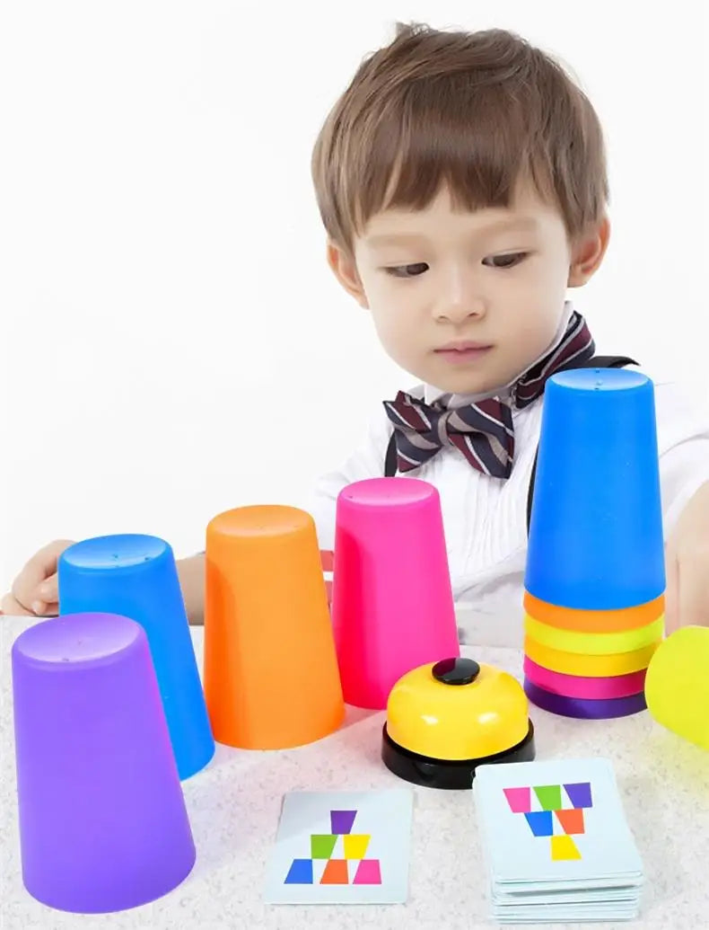 A child is holding a colorful stacking cup set and activity cards for early learning.