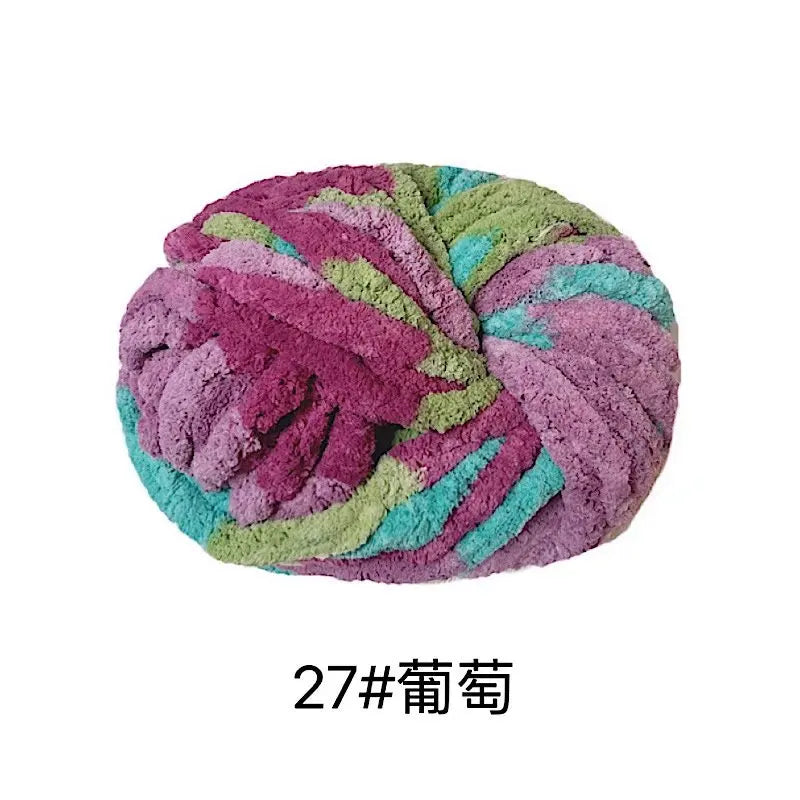A ball of purple and green chunky acrylic yarn for knitting and crochet