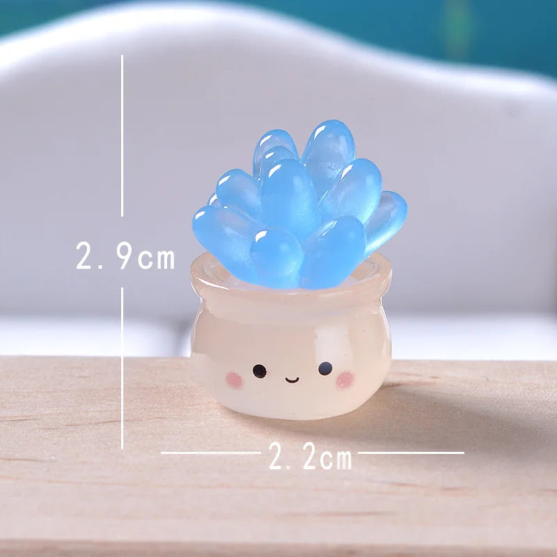 A small, translucent blue succulent cactus miniature with a cute face sits in a light ceramic pot.
