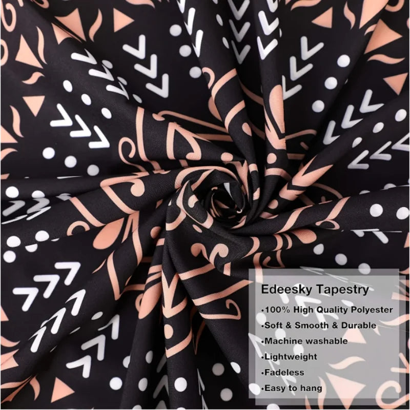 Black and white patterned tapestry fabric rolled up showing a repeating gothic design