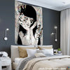 A dark wall hanging featuring a stylized, pale face with unsettling details in a horror style.