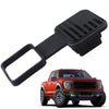 Black trailer hitch receiver cover with a flag emblem shown next to an orange pickup truck.