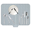 A silicone dish drying mat with a drainage ramp showing various silverware and a plate.