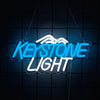 Blue neon sign spelling Keystone Light with a wavy outline against a dark background.
