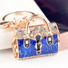 Gold-toned crystal rhinestone handbag keychain with a blue and black leopard print design