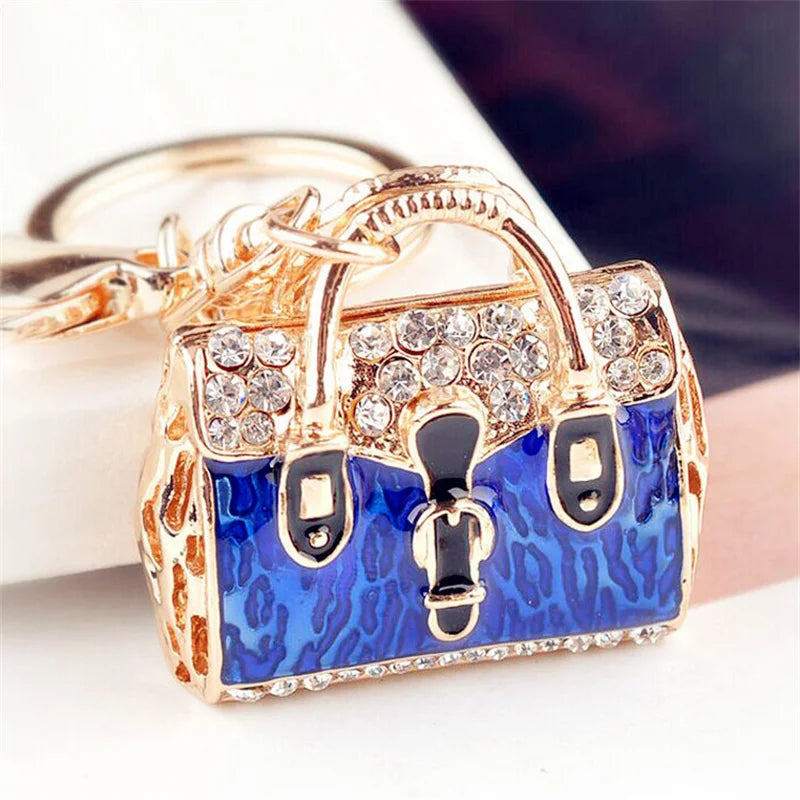 Gold-toned crystal rhinestone handbag keychain with a blue and black leopard print design