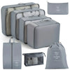 A set of gray travel packing cubes and storage organizer bags for clothing and items
