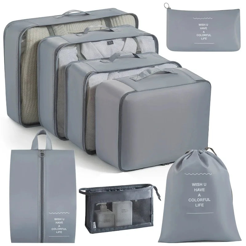 A set of gray travel packing cubes and storage organizer bags for clothing and items