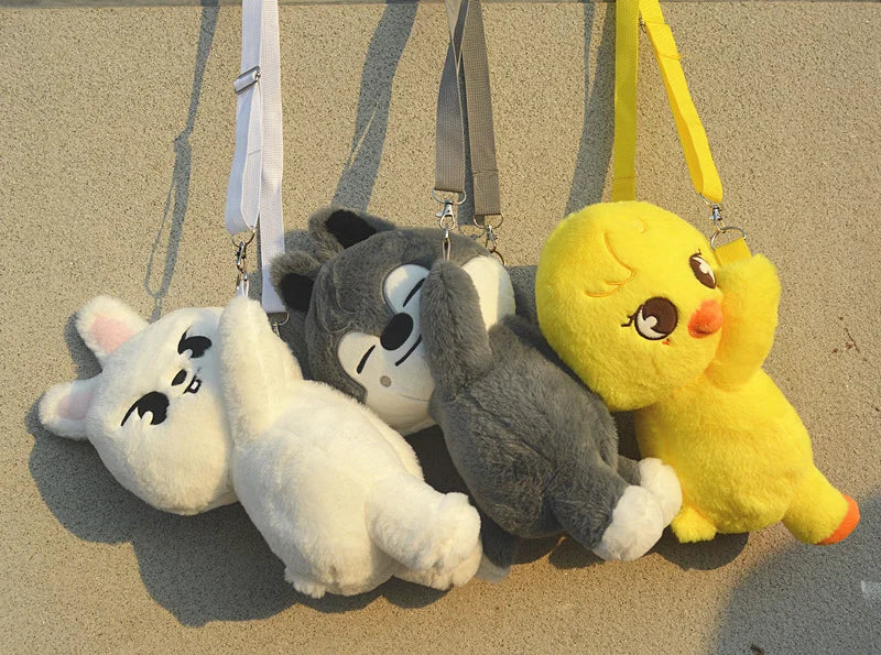 A collection of soft stuffed animal plush dolls featuring characters like Stitch and a yellow creature hanging from a keychai
