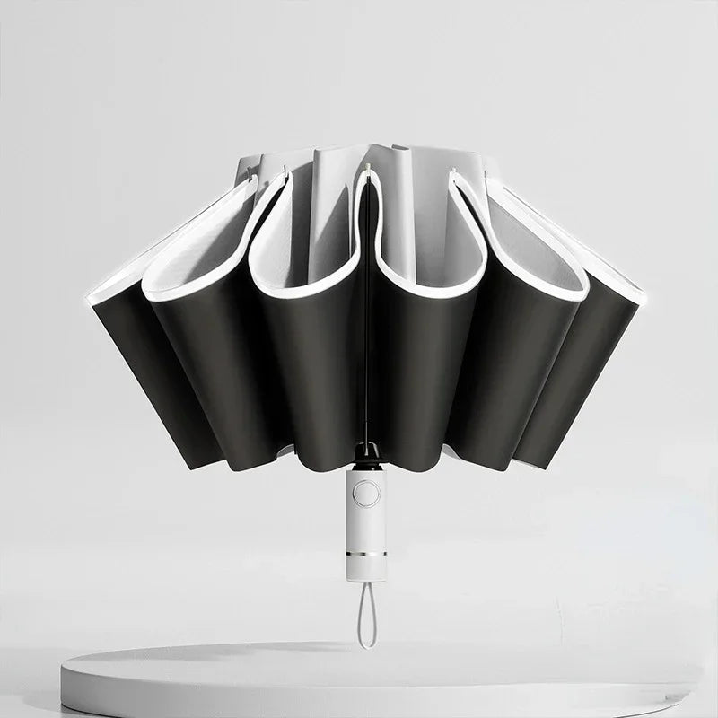 A black fully automatic reverse-folding windproof umbrella with UV protection shown against a light gray background.