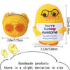 A yellow handmade crochet pocket hug doll with round glasses and an orange nose.