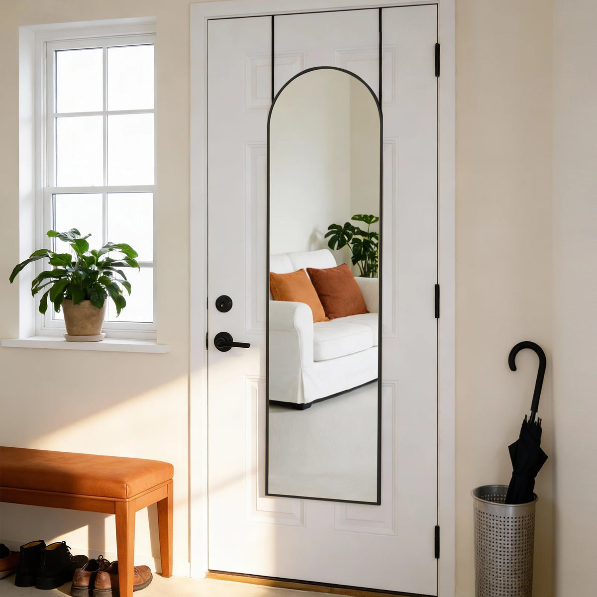 A full length wall mirror with an arched top and aluminum alloy frame is mounted on a white door.
