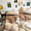 A beige duvet cover set with four pieces is displayed on a bed, surrounded by inspirational quotes and decorative elements.