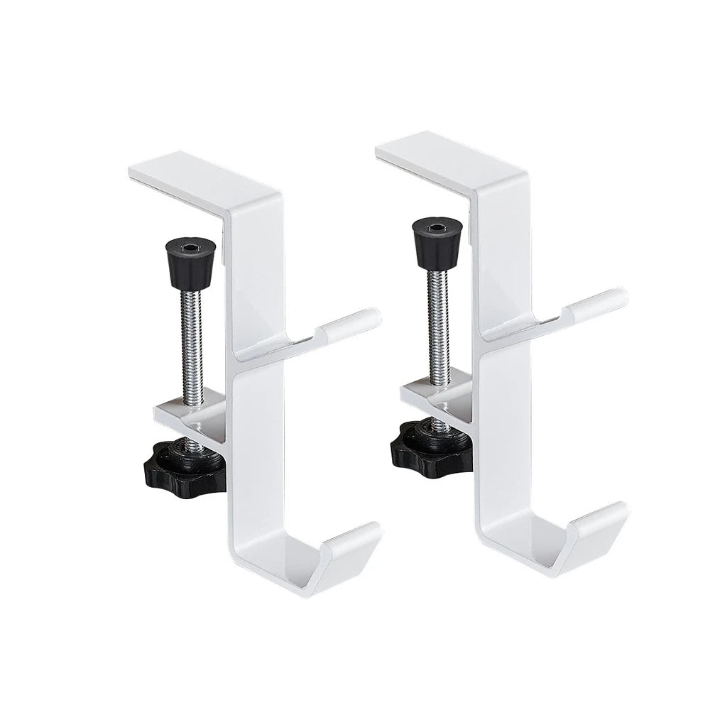 A pair of white foldable aluminum desk hooks designed for hanging bags and coats.