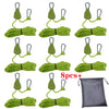 Eight green camping rope tensioners with pulley buckles displayed on a gray fabric bag.