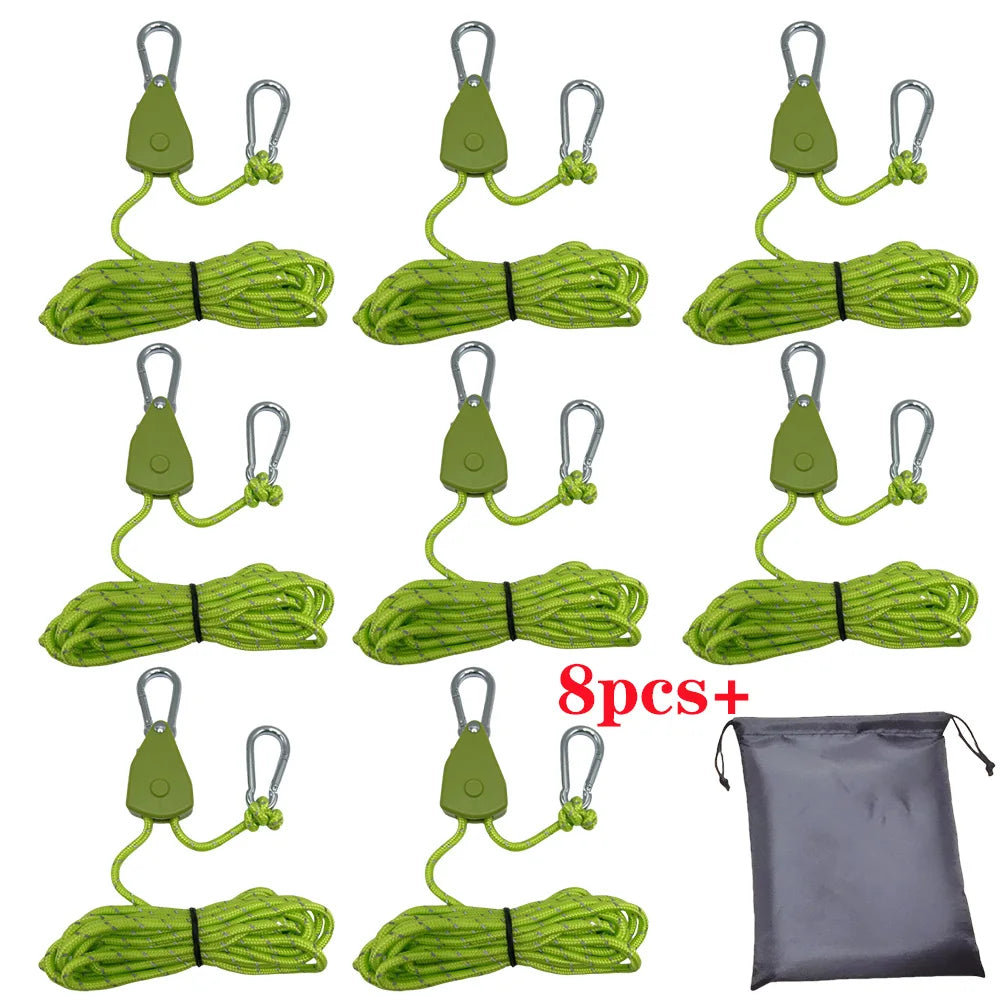 Eight green camping rope tensioners with pulley buckles displayed on a gray fabric bag.