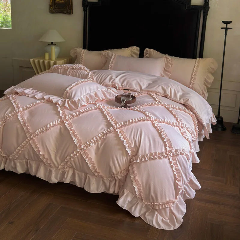 A pink ruffled duvet cover set with matching pillowcases displayed on a bed.