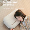 A woman rests her head on a Naturehike feather bone 2-in-1 inflatable pillow on a light beige surface.