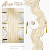 A light beige semi-sheer gauze table runner with gold accents displayed alongside a long, flowing strand of the fabric.