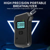 A black portable breathalyzer device with an LCD display is shown against a dark blue background.