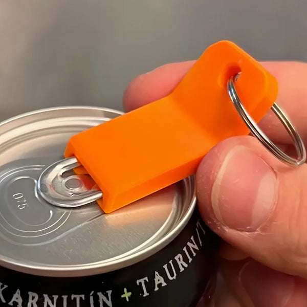 An orange keychain tool is shown opening a silver can, with a hand holding the item.