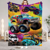A colorful flannel throw blanket featuring a cartoon design of monster trucks and a woman's face.