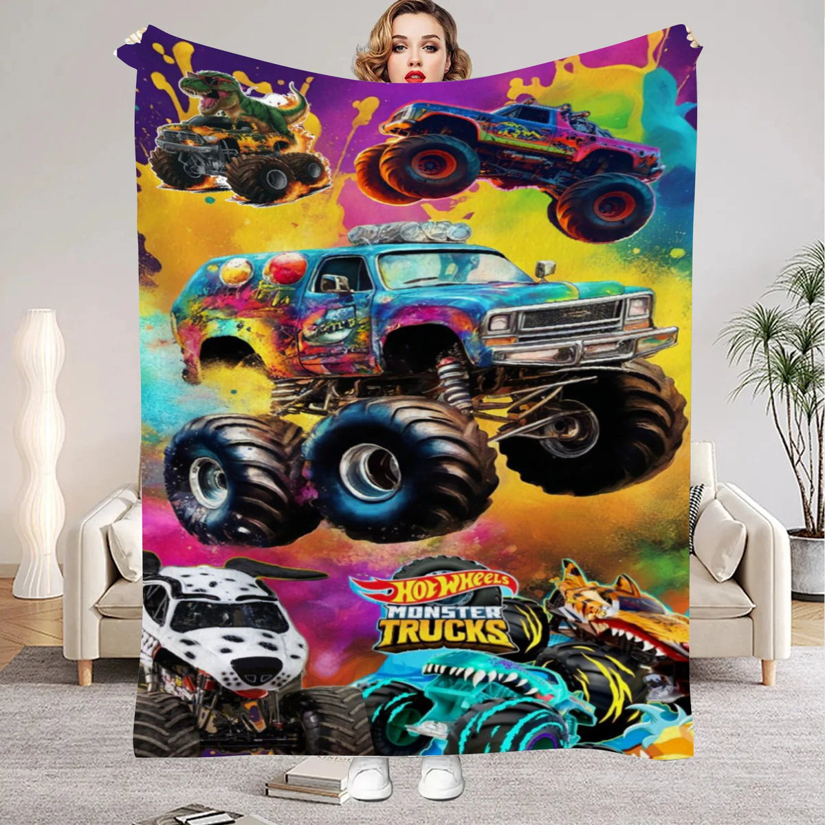 A colorful flannel throw blanket featuring a cartoon design of monster trucks and a woman's face.