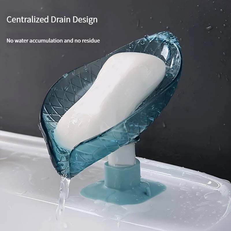 A blue self-draining soap dish with a white bar of soap is shown draining water into a sink.