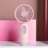 A pink mini USB rechargeable handheld fan with a circular grille is displayed on a white surface.