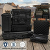 Black hard shell protective storage cases stacked on a wooden surface with a tool case open nearby.