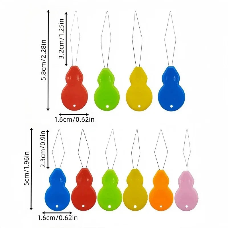 A set of plastic needle threaders in various colors including red, green, yellow, blue, and pink.