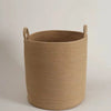 A beige handwoven cotton rope storage basket with handles.