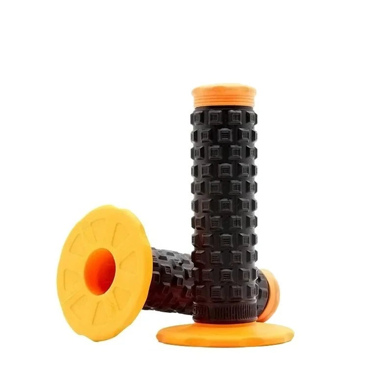 A close-up view of black and orange motorcycle handlebar grips for dirt bikes.