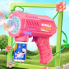 A pink bubble gun with lights is shown in a green frame, next to a colorful liquid container and green vines.
