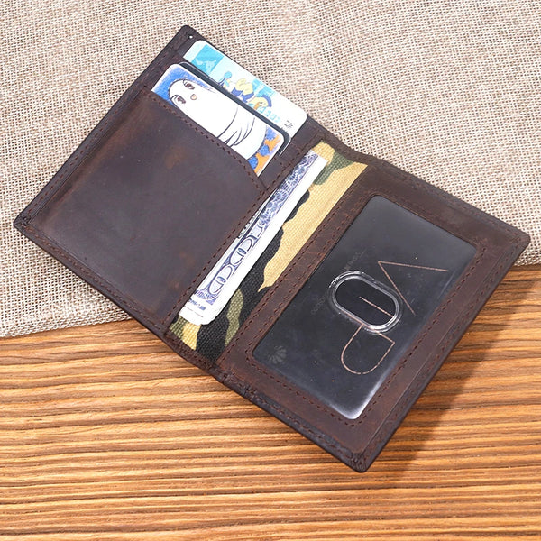 A brown leather card holder wallet displaying various cards and a clear slot for a card.