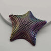 A 3D printed articulated starfish fidget toy with iridescent purple and green scales.