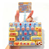 A colorful set of cartoon keycap fidget items and a related instruction card are held by a hand.